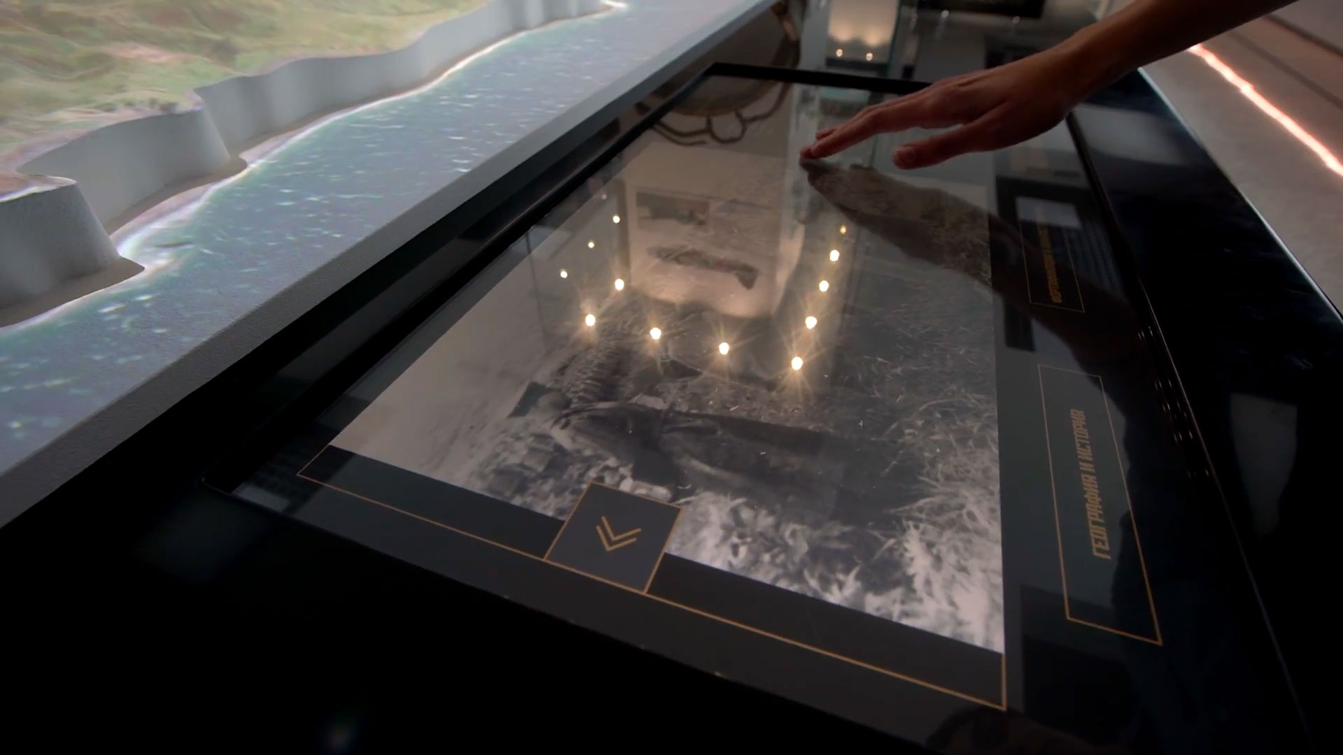 Interactive touchscreen table displaying digitized archival documents